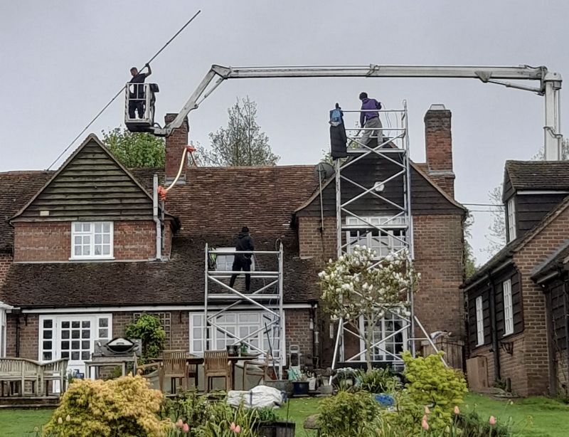 The Roof Moss Cleaners using cherry picker and scaffolding to clean roof safely and professionally in Swindon, Wiltshire